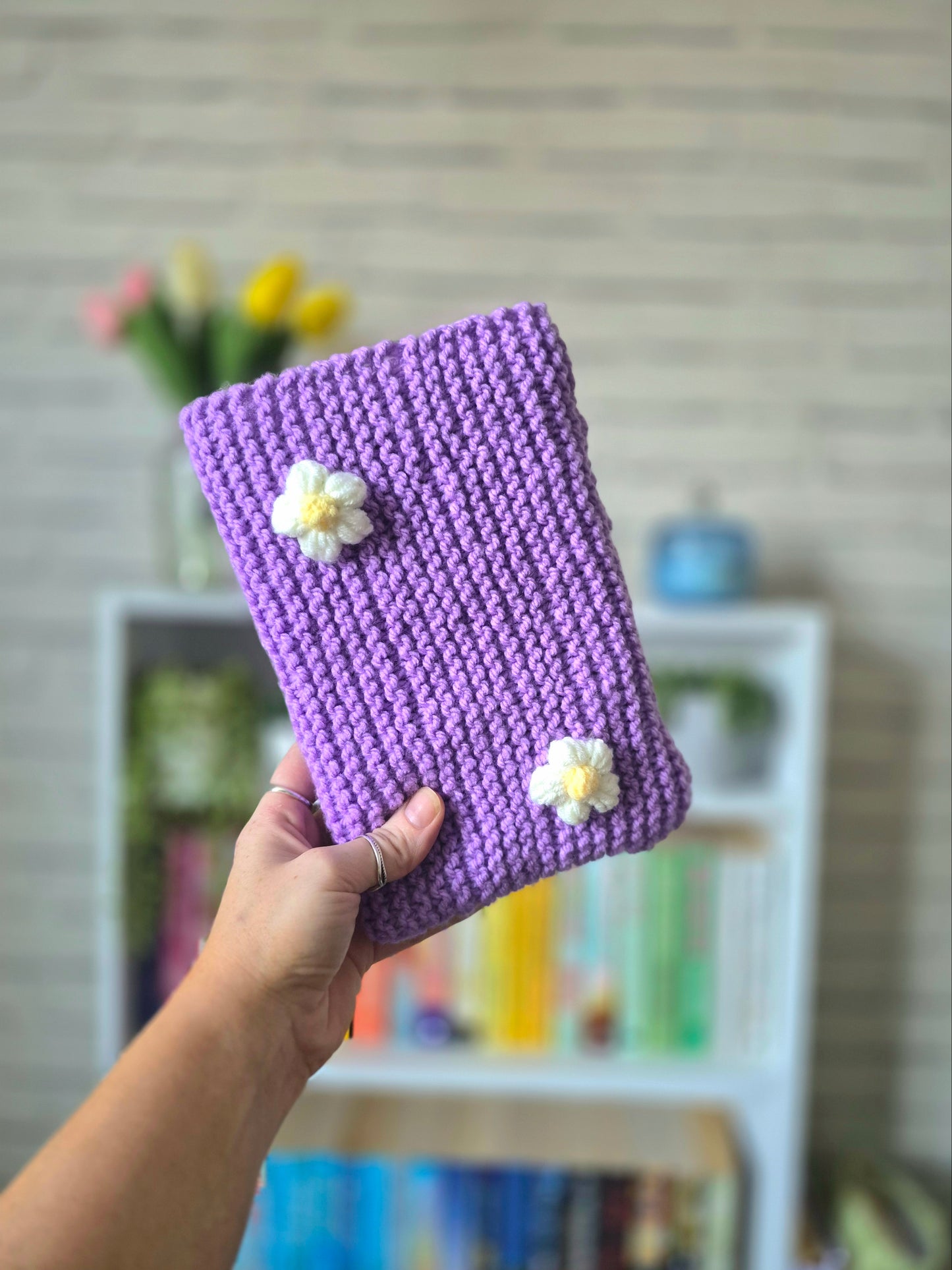 Purple Knitted book sleeve with white flowers