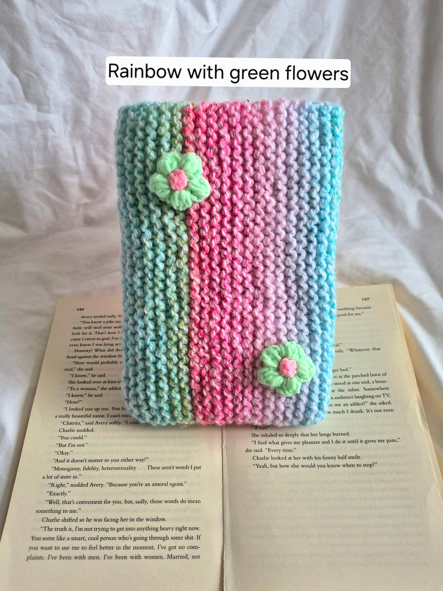 Rainbow knitted book sleeve with green flowers