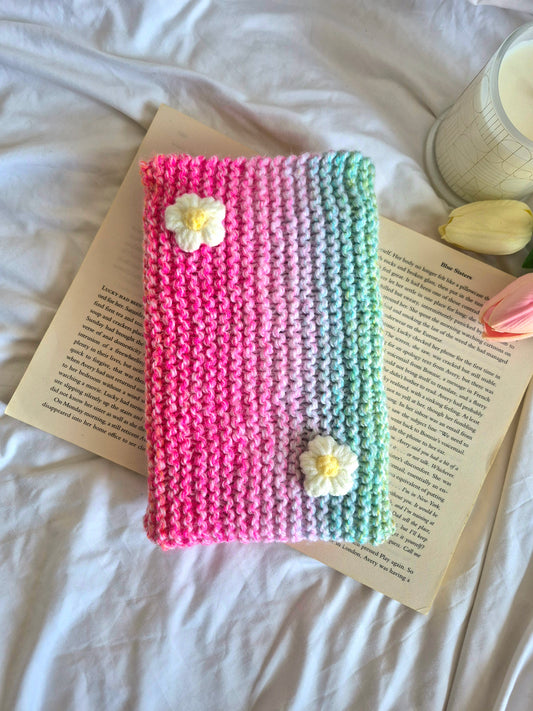 Rainbow knitted book sleeve with white flowers