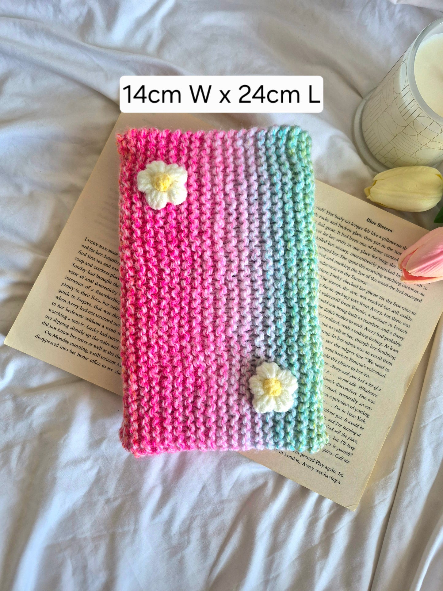 Rainbow knitted book sleeve with white flowers
