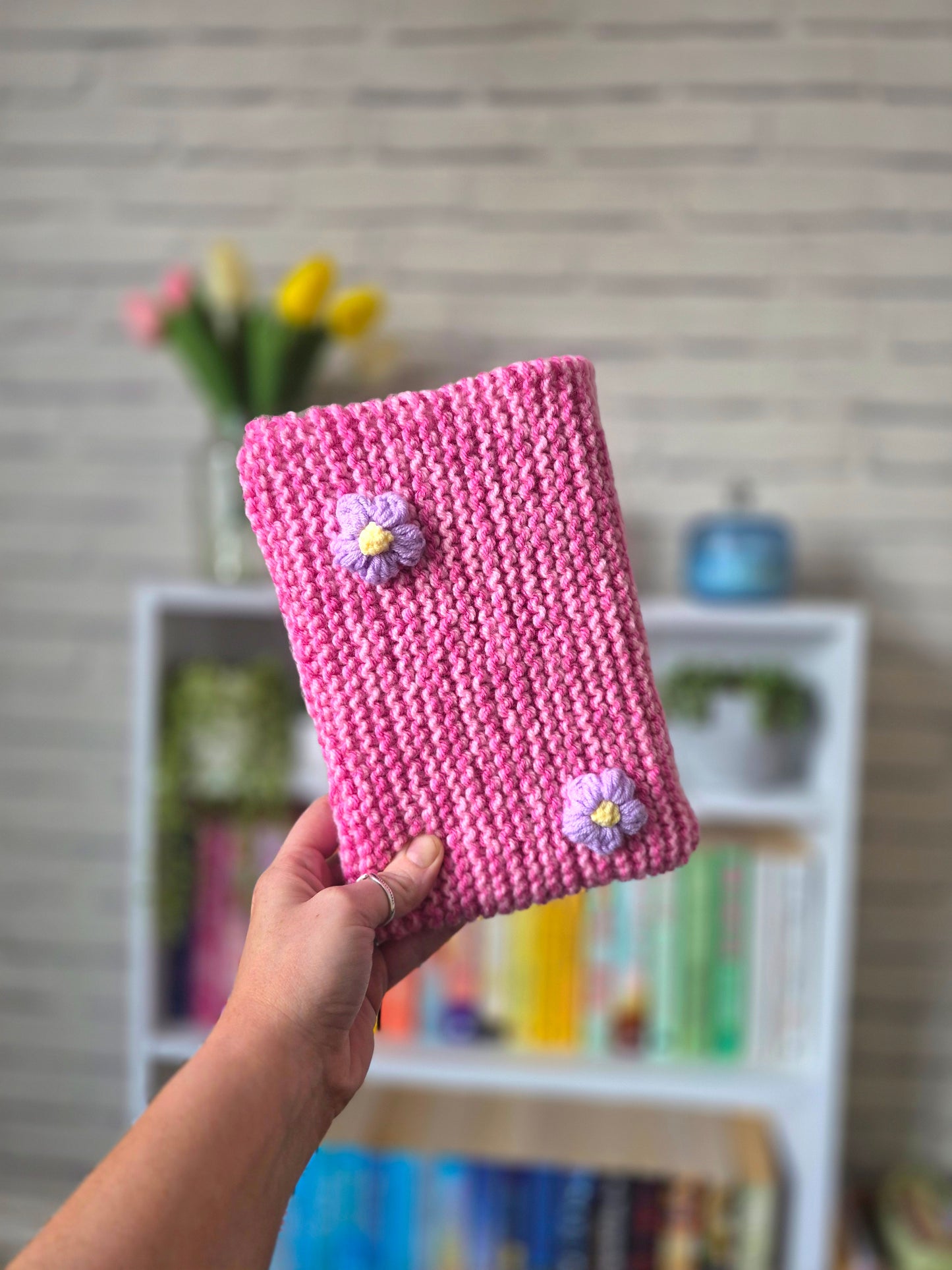 Pink Knitted book sleeve with purple flowers