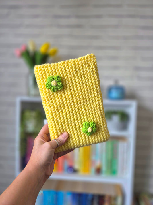 Yellow Knitted book sleeve with green flowers