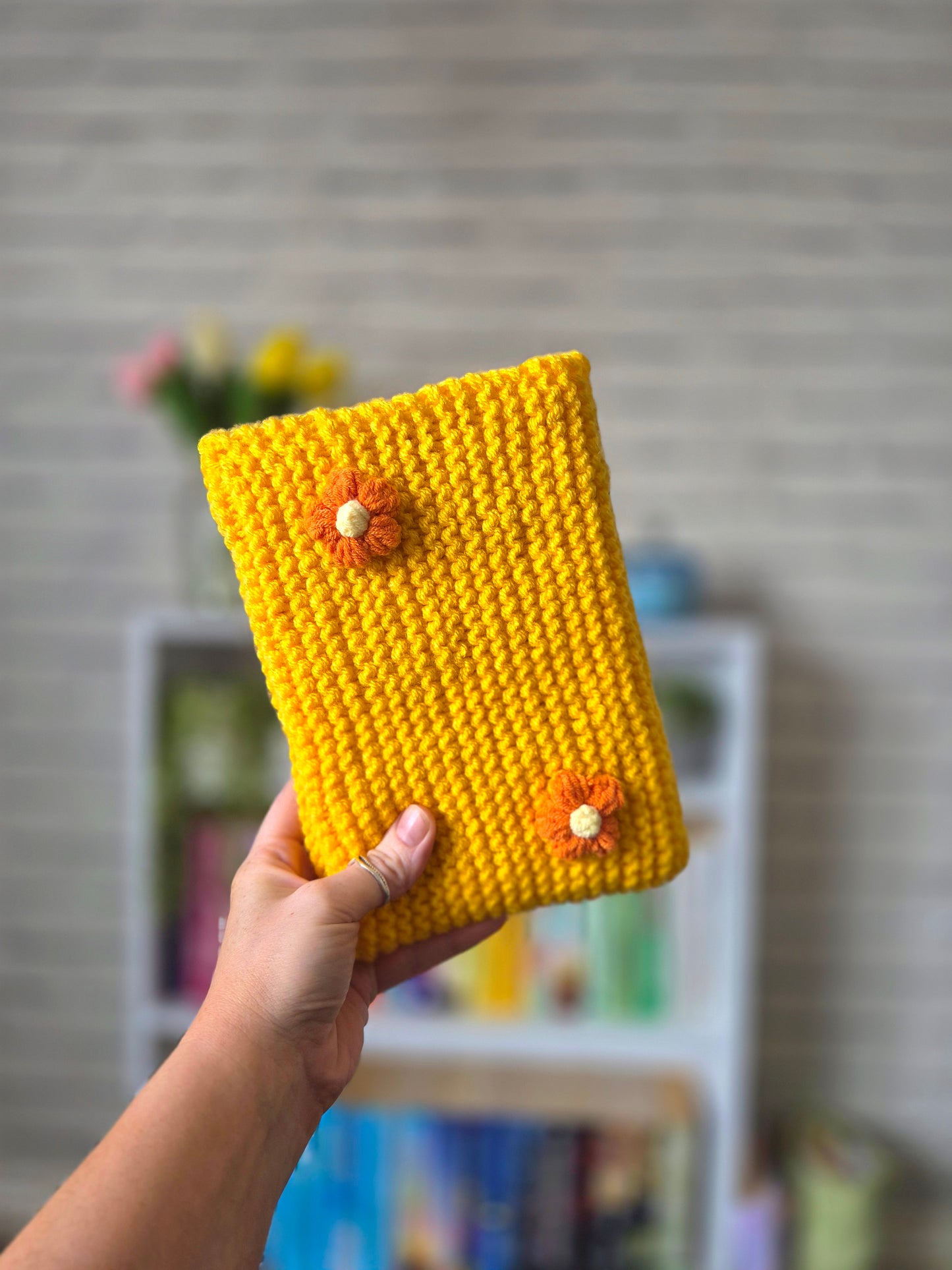 Dark Yellow/Orange Knitted book sleeve with orange flowers