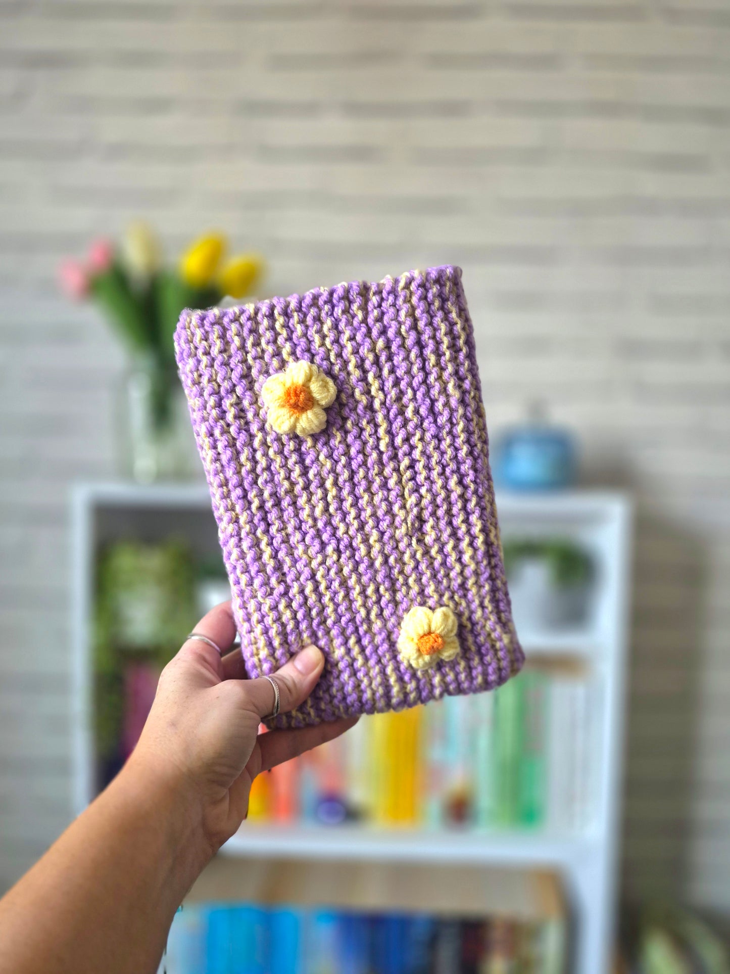 Purple and yellow Knitted book sleeve with yellow flowers