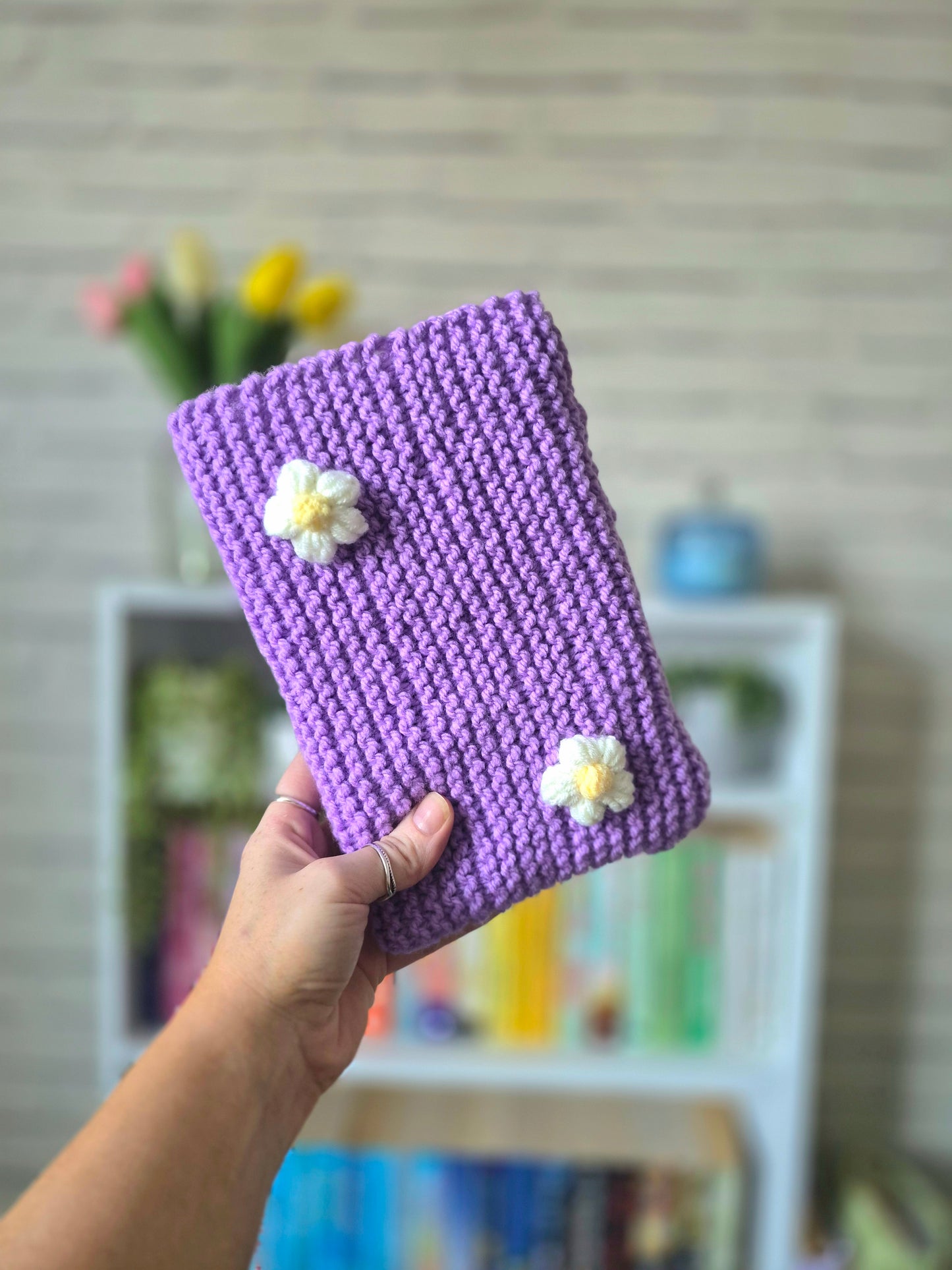 Purple Knitted book sleeve with white flowers