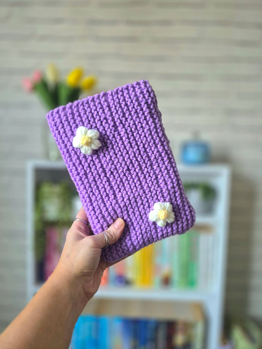 Purple Knitted book sleeve with white flowers