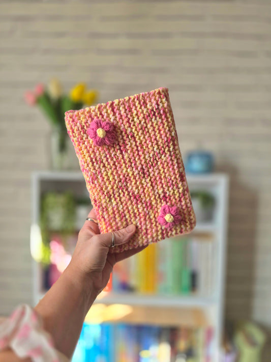 Pink and yellow Knitted book sleeve with pink flowers