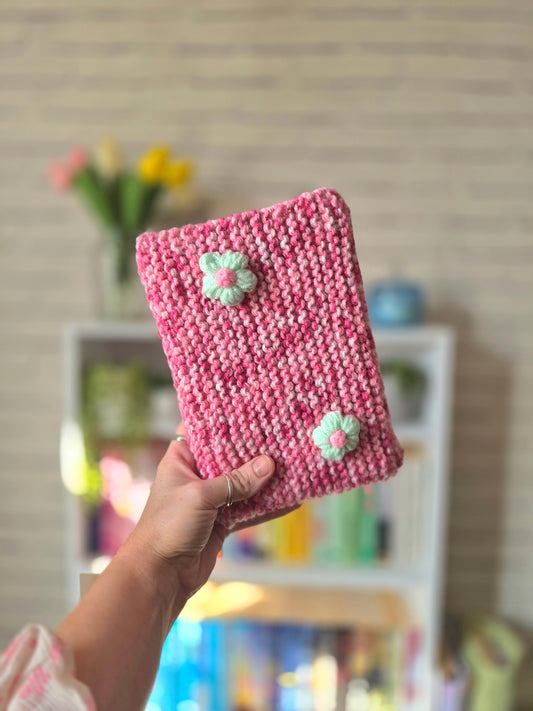 Pink and white Knitted book sleeve with green flowers