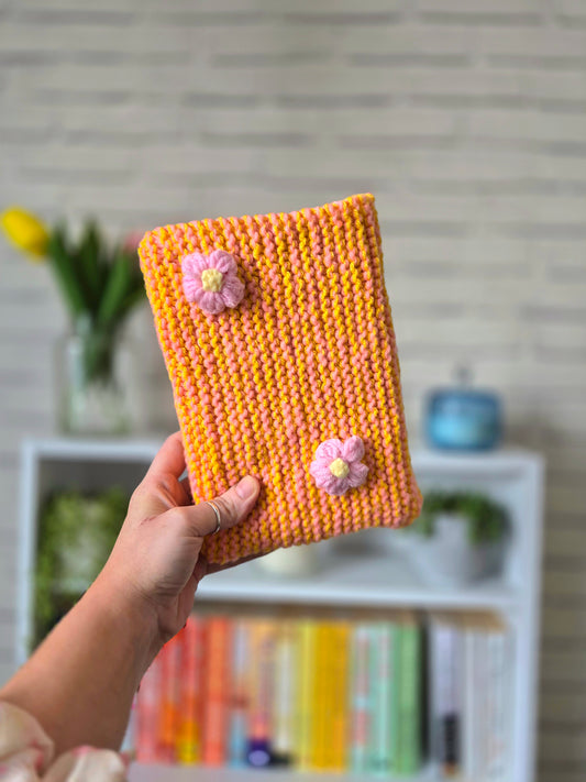 Orange and Pink Knitted book sleeve with pink flowers