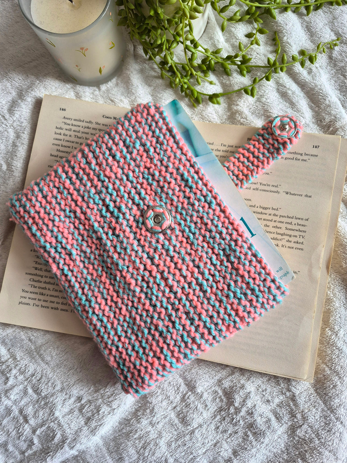 Pink and blue knitted book sleeve with snap button closure